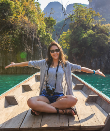 photo-of-woman-sitting-on-boat-spreading-her-arms-1371360